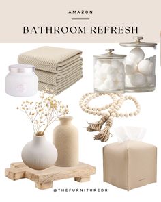 the bathroom refresh is organized with white and beige accessories, including soaps, candles, towels, and other items