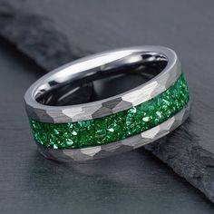 Materials - Tungsten, Emerald Finish - Hammered Band Color - Silver Band Width - 4mm, 8mm Free Rustic Wood Box Free Same Day Shipping This exquisite silver tungsten ring is the perfect way to set your outfit apart from the rest. Its unique design features a hammered silver band inlayed with green emeralds, making it a truly one-of-a-kind piece. The sleek and modern look of the tungsten gives this ring an understated elegance, perfect for any occasion. Not only does the silver provide a stunning backdrop for the emeralds, but it is also incredibly durable and will last for generations. The emeralds themselves are of remarkable quality, each cut to create sparkling facets that will catch the light from any angle. As if this wasn't enough, the green emeralds have special meaning and symbolism Emerald Engagement Ring Men, Emerald Ring Silver, Engagement Ring Men, Wedding Ring Womens, Rustic Wood Box, Emerald Band, Smaragd Ring, Mens Wedding Ring, Cheap Rings