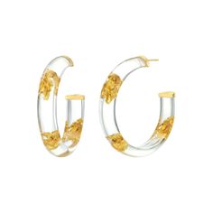 DISCO FEVER WHAT IT IS: Chic lucite hoops with one-of-a-kind gold-leaf patterns WHY IT’S SPECIAL: Glam and disco-ready, they put the 70s trend for lucite hoops back on the fashion map Gold leaf inclusions give every earring an element of uniqueness This playfully adorned lucite style can’t pass unnoticed GOOD TO KNOW: Handcrafted Lucite14K Gold Vermeil24K Gold LeafSize: 2" Due to their handmade nature, each piece is unique WHY WE LOVE GOLD AND HONEY: These four sisters bridge the gap between fas Gold Leaf Jewelry, Eclectic Jewelry, Resin Jewelry Diy, Gold Leaf Earrings, Classic Earrings, Statement Earring, Leaf Jewelry, Leaf Earrings, Silver Leaf