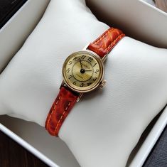 Vintage women's gilded small watch . The watch looks very elegant on a woman's wrist and goes well with other accessories. This watch perfectly captures the vintage style! The watch will be a great gift for lovers of vintage accessories. The watch is delivered in a beautiful box, so it is perfect as a gift. Peculiarities Brand Name: Chaika Made in USSR. Movement - mechanical. Case size - 18mm (0.7 inch) Strap:  eco-leather, length suitable for a wrist up to 18.5 cm (7.3 inches) Year of issue - 1980s Case: gilding Dial color - beige Condition - vintage, the watch is about 40 years old, but they are new, no one has worn them. . The clock works properly and shows the correct time. Serviced by a professional watchmaker. I will send the watch very quickly after purchase, as I am interested in y Vintage Womens Watch, Watch Y2k, Small Watch, Vintage Watches Women, Retro Watches, Watch Vintage, Watch For Women, Watches For Women, Women's Watches