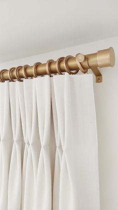 white curtains with gold metal rods hanging from them