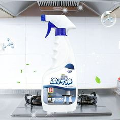 a bottle of cleaner sitting on top of a stove