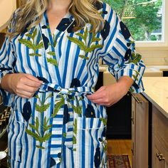 Start your morning off right! Slip into one of our bright & cheery robes while you prepare for your day. This 100% cotton robe features a vibrant Indian block print, in a rich, bold pattern of floral and blue stripes, finished off with white piping trim. Other details include 3/4 length sleeves, pockets and tying-sash. One size fits most. Details: Made in India Fabric: 100% cotton 3/4 length sleeves Pockets Includes tying-sash Cotton Long Sleeve Overnight Robe, Blue Cotton Robe For Home, Blue Cotton Home Robe, Long Sleeve Cotton Robe For Hospital, Spring Cotton Home Robe, Blue Cotton Robe For Spring, Blue Spring Robe For Home, Blue Home Robe For Spring, Blue Spring Home Robe