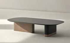 a black table with wooden legs on a white floor