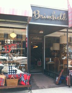 a store front with lots of bags in the window