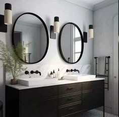 a bathroom with two sinks and mirrors above them