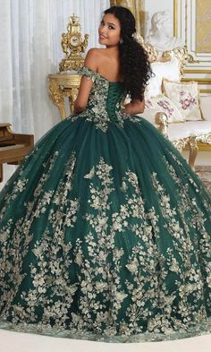 a woman in a green ball gown with flowers on it