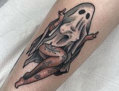 a woman with a ghost tattoo on her arm