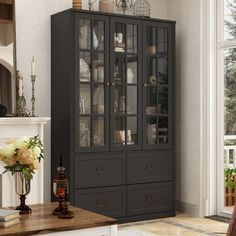 a tall black china cabinet with glass doors in a living room next to a fireplace