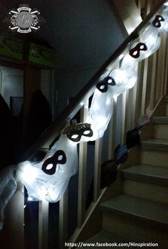 some lights that are on the side of a stair case