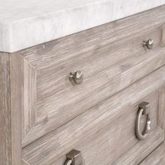 the drawers are made from wood and have handles on each drawer, which has two knobs