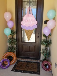 an ice cream sundae is on the front door and balloons are in the air