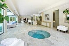 a large living room with a hot tub in the center