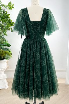 This stylish dark green midi dress features delicate ruffle sleeves and a flattering V-neckline. Made of high-quality tulle, it combines comfort and elegance, making it perfect for any occasion. The unique print adds a touch of charm to your look, making you stand out from the crowd. Bust and Skirt with full lining. 100% Polyester 100% Recycled polyester lining Concealed zip at center back Imported Dark Green Midi Dress, Patterned Bridesmaid, Wedding Guest Outfits, Dream Aesthetic, Ruffle Sleeve Dress, Green Midi Dress, Ruffle Sleeves, Tea Length, Prom Party