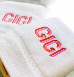 two white towels with the word gigi on them