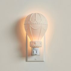 a light that is on the side of a wall with a hot air balloon in it