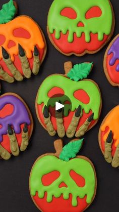 decorated halloween cookies on a black surface