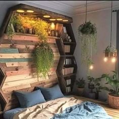 a bed that has some plants on the headboard and bookshelf above it