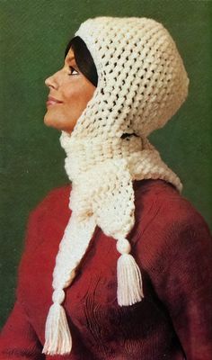 a woman wearing a white crocheted hat and scarf