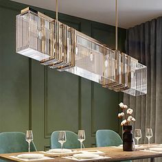 a dining room table with chairs and a chandelier hanging from it's ceiling