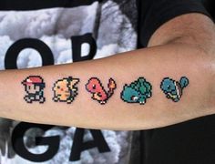 a person with a tattoo on their arm that has four different types of nintendo characters