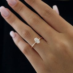 a woman's hand with a diamond ring on it