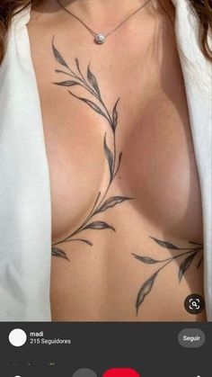 a woman's chest with tattoos on it