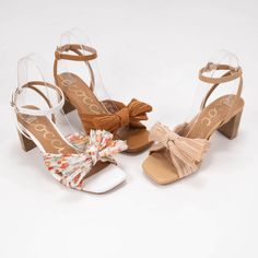 White Heels With Bow And Open Heel, Spring High Heels With Bow Straps, White Open Heel Heels With Bow, Chic White Sandals With Bow, White Open Toe Heels With Bow Straps, Feminine Summer Heels With Bow Straps, Spring Low Heel Shoes With Bow Straps, Summer High Heels With Bow Straps, Spring Bow Heels With Open Heel