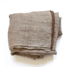 two pieces of cloth folded on top of each other, one brown and the other white