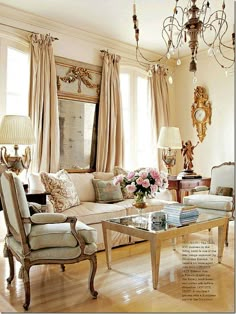 a living room filled with lots of furniture next to a window covered in drapes