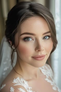 a woman with blue eyes wearing a wedding dress