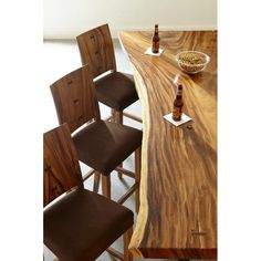 a wooden table topped with lots of brown chairs next to a bowl of oatmeal