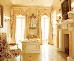 an elegant living room with fireplace, chandelier and ornate furniture in the center