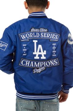 Los Angeles Dodgers 2020 World Series Champions Bomber Jacket with Hidden Snap Tab Buttoned Closure Winter Collegiate Outerwear With Ribbed Collar, Collegiate Outerwear With Ribbed Collar For Winter, Collegiate Style Outerwear With Ribbed Collar For Winter, Blue Outerwear With Embroidered Logo For College, Blue Embroidered Outerwear For College, Blue College Varsity Jacket With Button Closure, College Blue Varsity Jacket With Button Closure, Blue Varsity Jacket With Button Closure For College, Blue Varsity Jacket With Ribbed Cuffs And Baseball Collar