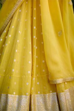 Illuminate the occasion in this daffodil yellow chanderi jacquard lehenga, adorned with enchanting lurex patchwork and intricate thread embroidery. Paired gracefully with an organza dupatta, this ensemble exudes elegance and charm. Crafted with meticulous attention to detail, it's the perfect choice for those seeking to make a radiant statement at any special occasion. Semi-stitched Yellow Palazzo Set In Chanderi, Festive Yellow Palazzo Set With Cutdana, Bollywood Style Yellow Chanderi Palazzo Set, Festive Yellow Raw Silk Palazzo Set, Designer Yellow Sharara With Chikankari Embroidery, Yellow Silk Salwar Kameez With Chikankari Embroidery, Designer Yellow Anarkali Set With Gota Work, Silk Yellow Sets With Sheer Dupatta, Yellow Silk Salwar Kameez With Gota Work