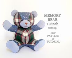 a blue teddy bear sitting on top of a white background with the words memory bear written below it