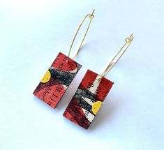 These earrings are made from little pieces of hand printed papers. The paper has been varnished to protect it and they they made of many layers of card and paper, so won't bend. They are a redy brown with black ink. The earrings are approx. 5.8cm x 1.6cm. The earrings wires are gold plated. Shrinking Paper Earrings, Papier Mache Earrings, Scrapbook Paper Earrings, Yupo Paper Earrings, Paper Bead Earrings, Hole Puncher, Paper Earrings, Paper Jewelry, Collage Paper