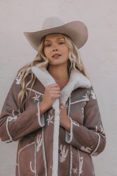 Model is 5'8 1/2" wearing a size extra small Long sleeves Lapel collar Button-down placket Two patch handwarmer pockets Lined Solid brown with western conversation print Imported Faux suede and shearling Western Style Outerwear For Rodeo In Fall, Western Style Outerwear For Fall Ranch, Western Outerwear For Rodeo In Fall, Western Style Fall Outerwear For Ranch, Western Style Fall Outerwear For Rodeo, Western Style Winter Outerwear For Rodeo, Brown Winter Outerwear For Rodeo, Western Winter Outerwear For Ranch, Western Style Fall Ranch Outerwear