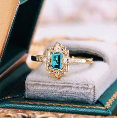 Step into the elegance of a bygone era with our Natural London Blue Topaz Ring, beautifully set in 14K yellow gold vermeil. This exquisite engagement ring draws inspiration from the opulent Art Deco period, blending vintage charm with timeless sophistication.►The centerpiece is a stunning London blue topaz, renowned for its deep, captivating hue that evokes the mysterious beauty of twilight skies. The intricate detailing of the band, adorned with delicate filigree patterns and sparkling accents, Vintage Promise Ring, Art Deco Engagement Rings, Mysterious Beauty, Filigree Pattern, Engagement Rings For Women, Topaz Engagement Ring, London Blue Topaz Ring, Art Deco Engagement, Bygone Era