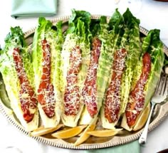 a platter filled with lettuce wrapped in bacon