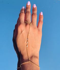 "18 Karat Gold Filled CZ Hand Chain Bracelet length:  Option A: 7\" + 1.5\" Extension Option B: 6.5\" - 3mm Beaded Bracelet Option C: 7\" + 1.5\" Extension Finger Loop: 4\"  Material: 18 Karat Gold Filled, Hypoallergenic. Tarnish Resistant. Gold-filled does not de-laminate or peel like Gold plated Jewelry nor does it tarnish as readily as silver. Generally speaking, gold filled is better quality and will have a much longer lasting color than plated jewelry. Gold filled jewelry is an excellent op Minimalist Adjustable Chain Bracelet For Party, Adjustable Cubic Zirconia Chain Bracelets, Adjustable Chain Bracelet With Cubic Zirconia, Adjustable Cubic Zirconia Bracelet With Delicate Chain, Adjustable Delicate Chain Bracelet With Cubic Zirconia, Delicate Metal Bracelets For Party, Adjustable Dainty Chain Bracelet For Parties, Adjustable Delicate Cubic Zirconia Chain Bracelet, Delicate Chain Bracelets For Parties