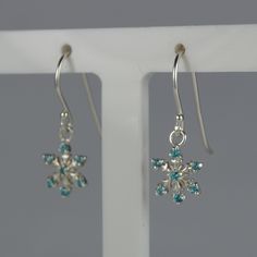 "Sterling Silver Snowflake Earrings. This is a pair of fun snowflake design sterling silver drop earrings, stamped 925 on the earwire. They are both beautiful and robust and designed for pierced ears. They have six very sparkly blue cubic zirconia's on each earring and are just perfect for the festive season. Drop length: Approximately 23mm Maximum Width: Approximately 10mm We have lots of other fun festive jewellery, please follow this link to see all we have in stock: www.etsy.com/uk/shop/LoveYourJewellery?ref=shop_sugg&section_id=24715211 Please visit our shop to view the full range of pendants/necklaces we have in stock  www.etsy.com/uk/shop/LoveYourJewellery Please note that although our jewellery is supplied in a plastic box for presentation and to give our jewellery protection in th Snowflake Earrings, Silver Snowflakes, Sterling Silver Drop Earrings, Snowflake Designs, Jewelry Manufacturers, Christmas Earrings, Silver Drop Earrings, Fun Earrings, Sterling Earrings