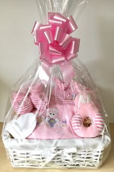 a white basket filled with baby items on top of a table