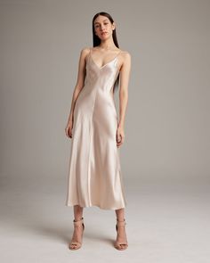 This elegant bias-cut slip dress features a spaghetti strap and flattering V Neck for a fresh, yet refined look. This perfect basic can be worn for life, dressed up, or dressed down, for the perfect effortless ensemble. 100% Silk Charmeuse Made in New York City Product Care: Dry Clean Only Dress Elegantly, Dress Outer, White Silk Dress, Cami Slip Dress, Bias Cut Dress, Silk Dress Long, Midi Slip Dress, Silk Slip Dress, Silk Charmeuse