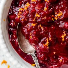 cranberry sauce in a white bowl with a spoon