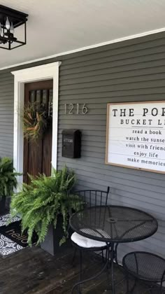 the porch is decorated with potted plants