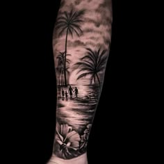 a man's arm with palm trees and people on the beach