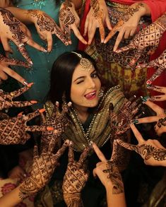 a woman with her hands covered in henna