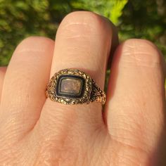 "A stunning Georgian era mourning ring in a rare state of complete preservation, with all the hallmarks, original inscription, enamel and hair. All in original condition. It has a central locket compartment glazed with its original rounded, beveled glass and accessible only by a jeweler. This has a black enamel inner bezel and an engraved gold outer bezel. The beautiful hand engraved detailing continues throughout the piece.  The back of the ring face is inscribed: \"James Slemeck Died 16 Feb\"y Antique Engagement Rings Georgian, Victorian Enamel Ring For Anniversary, Victorian Enamel Ring Engraved For Anniversary, Victorian Engraved Enamel Ring For Anniversary, Vintage Hallmarked Rings For Memorial, Heirloom Oval Engraved Enamel Ring, Vintage Gold Ring For Memorial, Heirloom Engraved Ring With Intaglio For Collectors, Heirloom Engraved Oval Enamel Ring