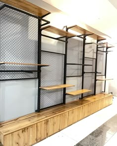 the shelves are made out of wood and metal with wire mesh on them, along with shelving